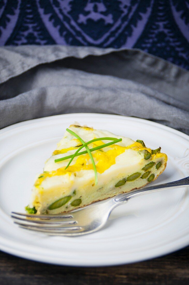 A slice of green asparagus frittata