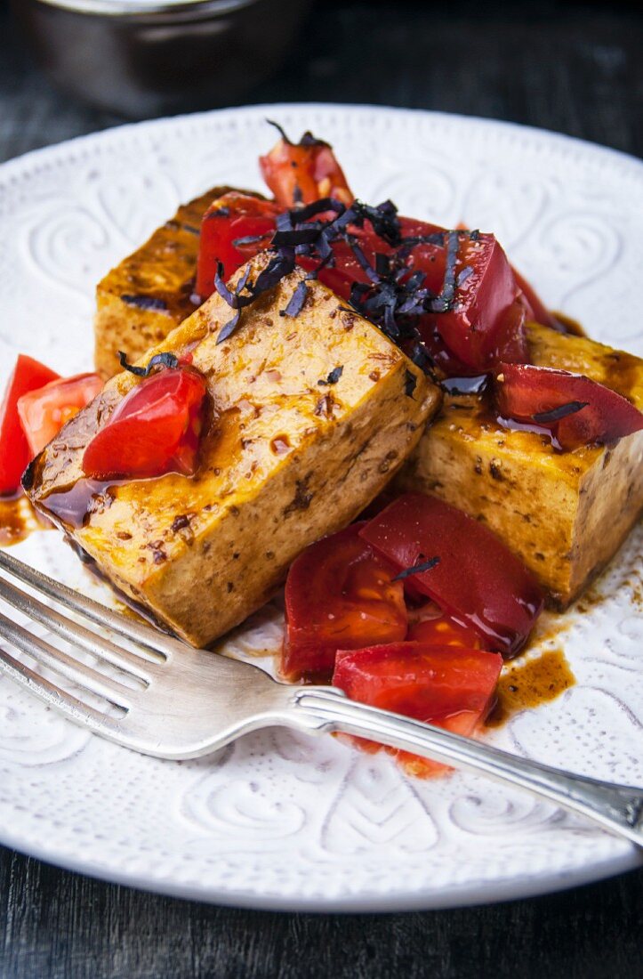 Tofu fried in balsamic vinegar with tomato salad