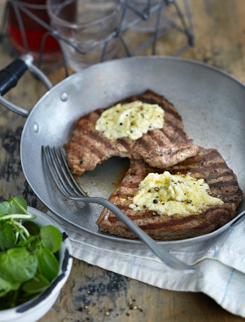 Grilled steaks with herb butter