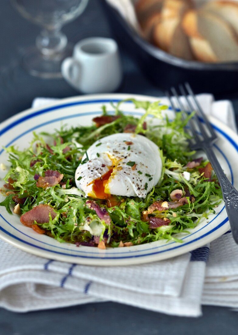 Frisee lettuce with bacon and a poached egg