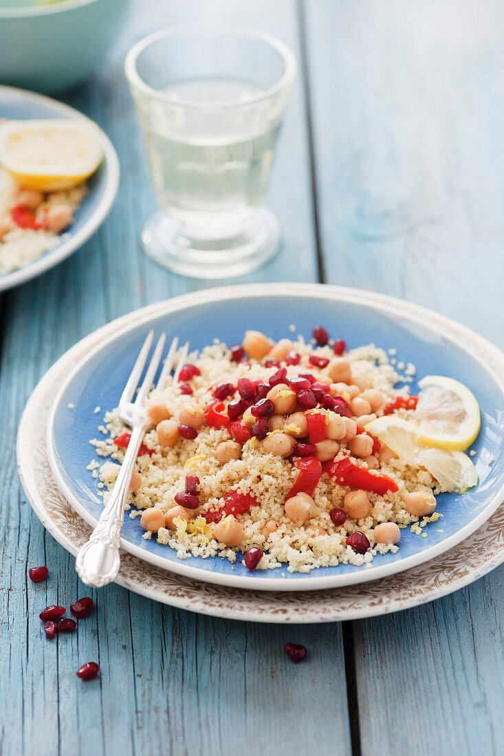 Couscous with chick peas, roasted peppers, pomegranate seeds and cumin
