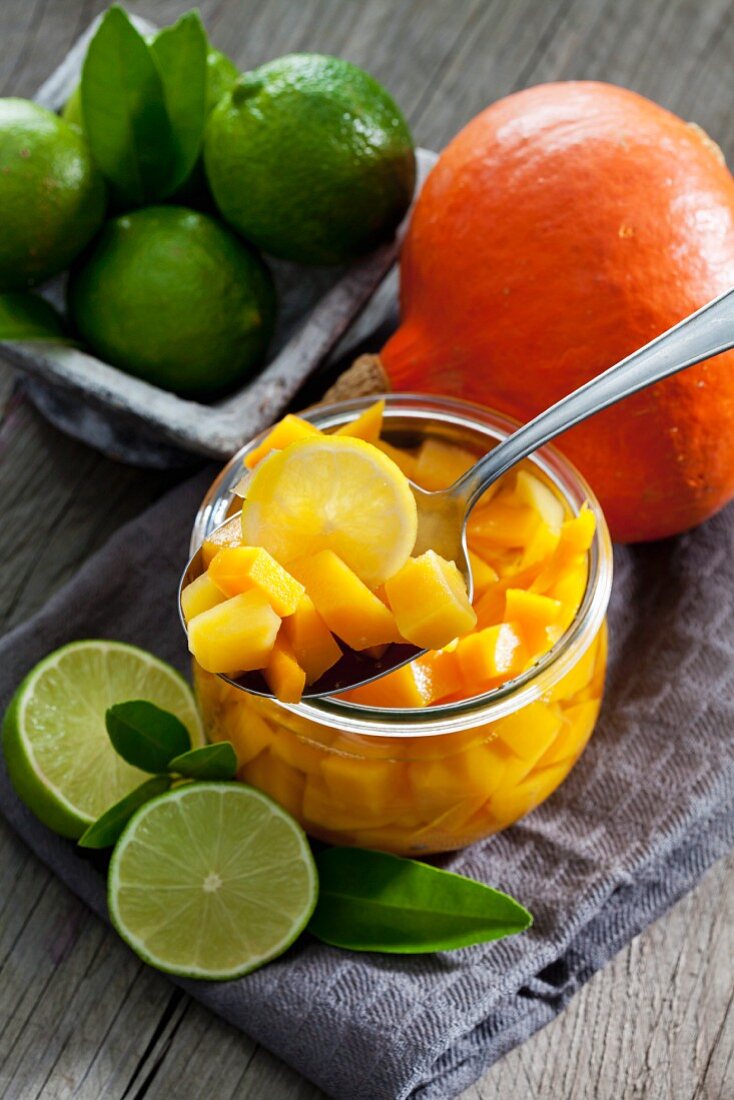 Pickled pumpkin with limes in a preserving jar