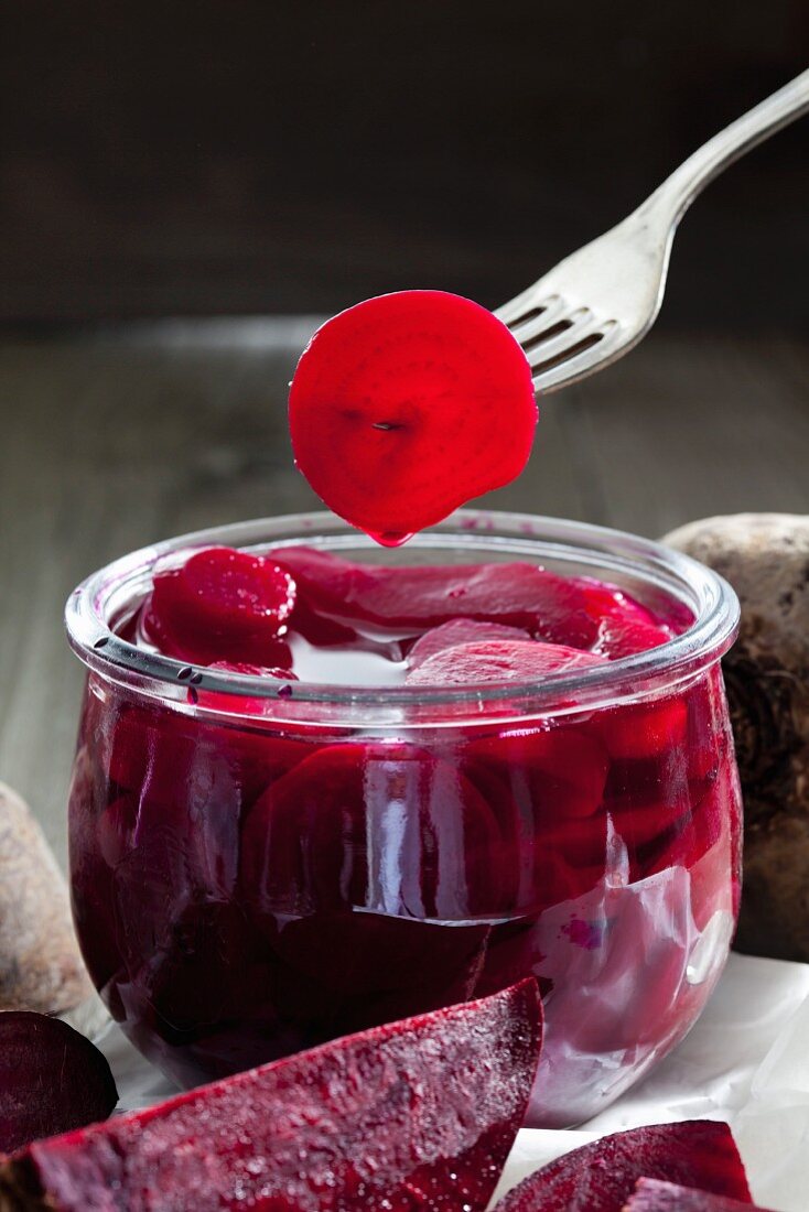 Pickled beetroot in a preserving jar and on a fork