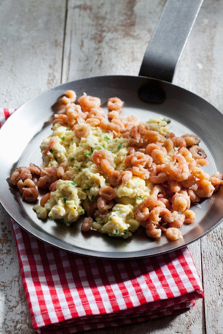 Scrambled eggs with shrimps in a pan