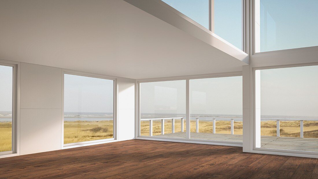 Empty holiday home with glass walls amongst sand dunes on North Sea beach