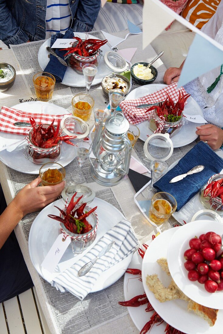 A family having a crayfish dinner outside a house