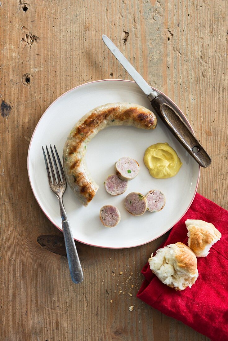 Grilled sausage with mustard and a roll