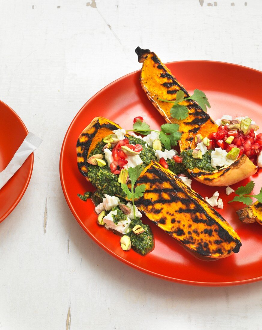 Grilled butternut squash with coriander pesto, pomegranate, sheep's cheese and pistachios