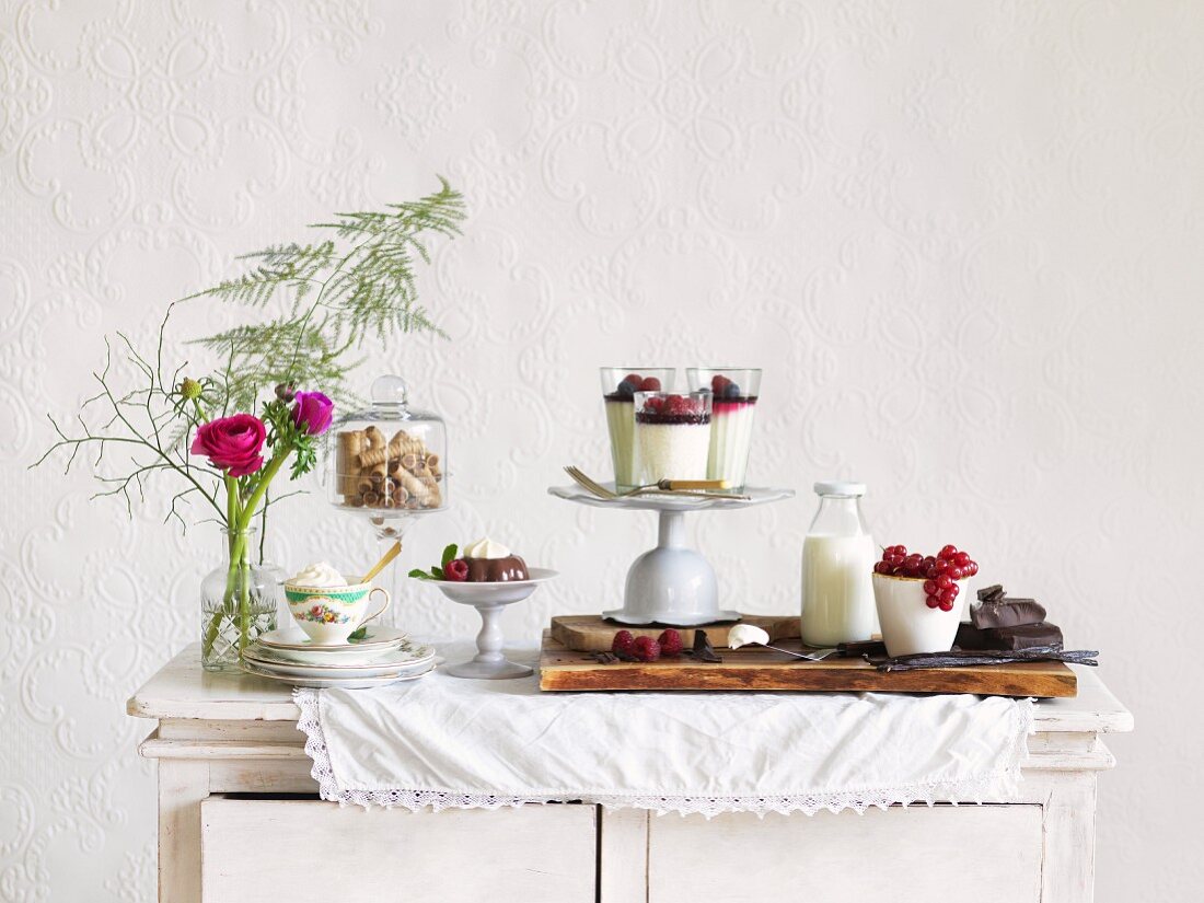 Verschiedene Puddings mit Zutaten auf Holzschränkchen