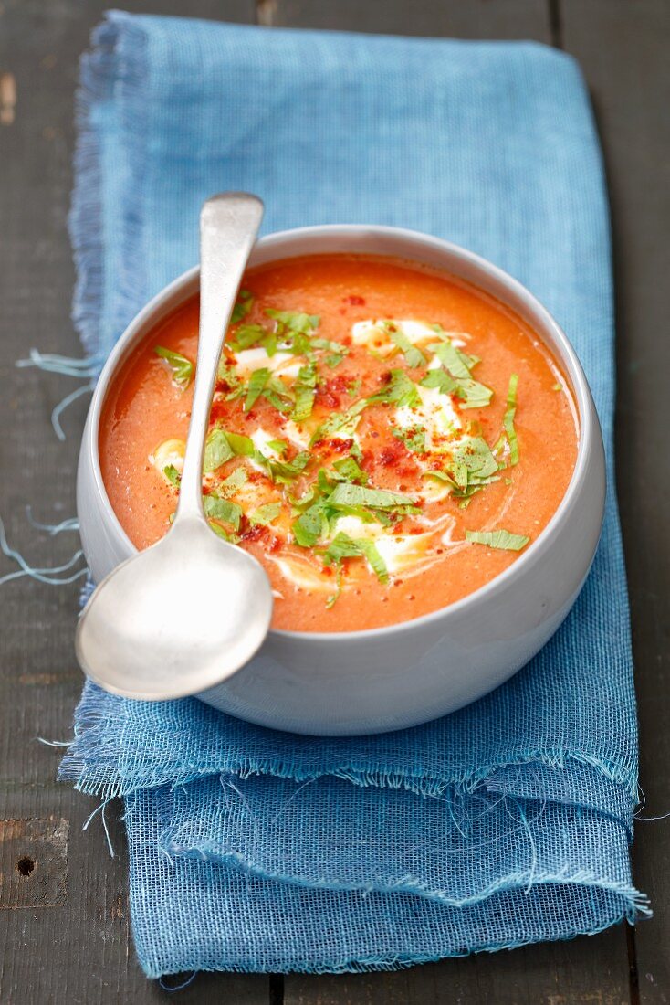 Cream of tomato and lentil soup with celery leaves