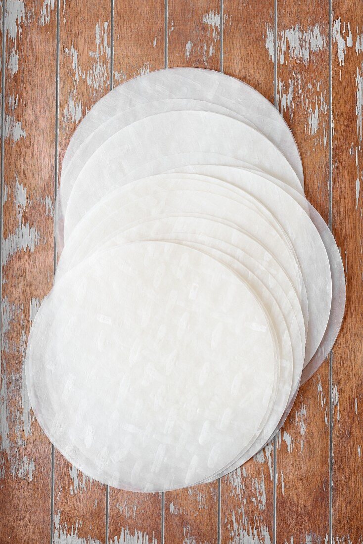 Round sheets of rice paper on a wooden surface