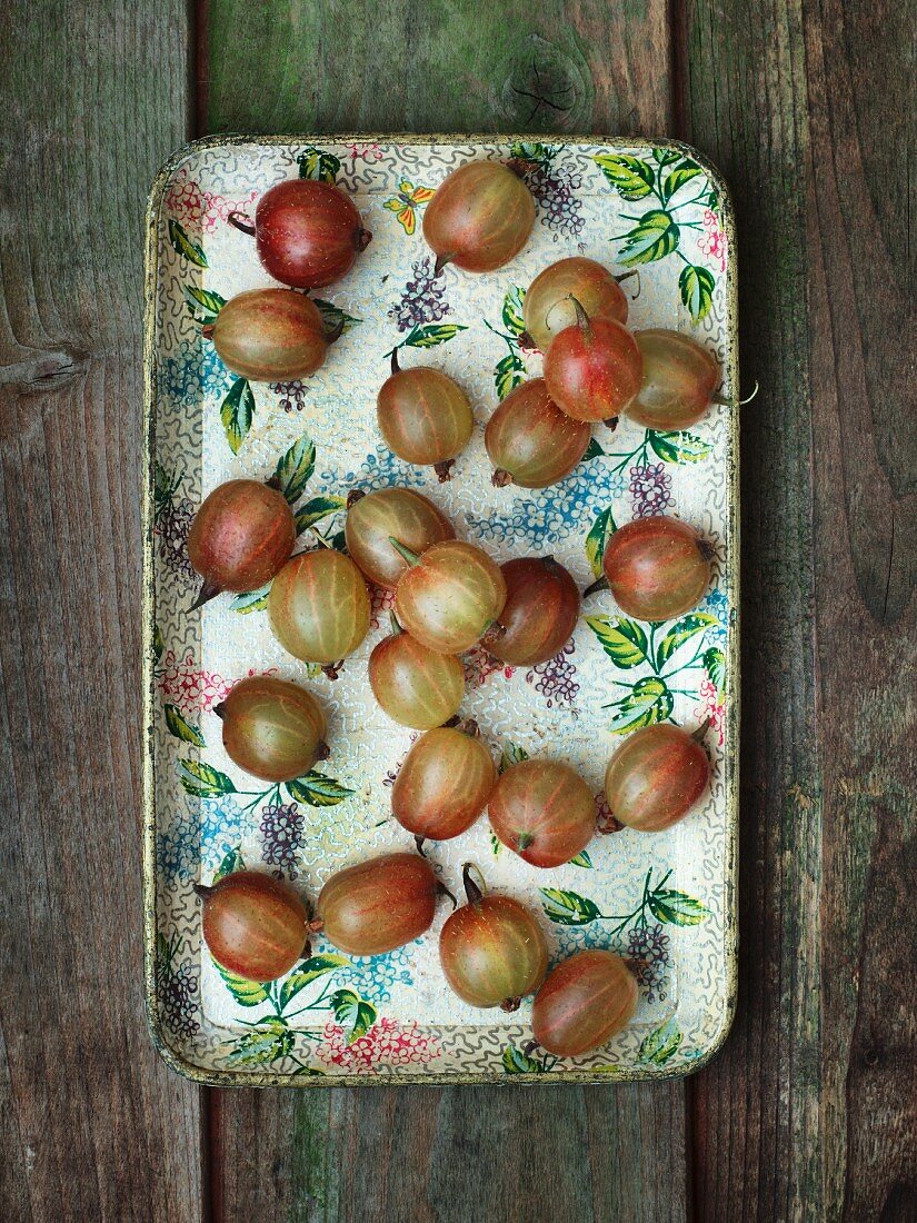 Fresh gooseberries on a vintage tray