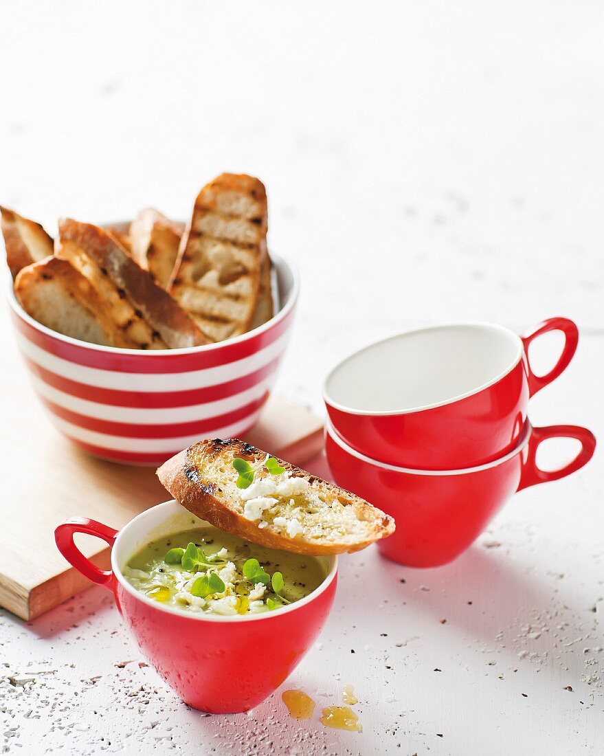 Cold lettuce and pea soup with avocado, feta and bruschetta