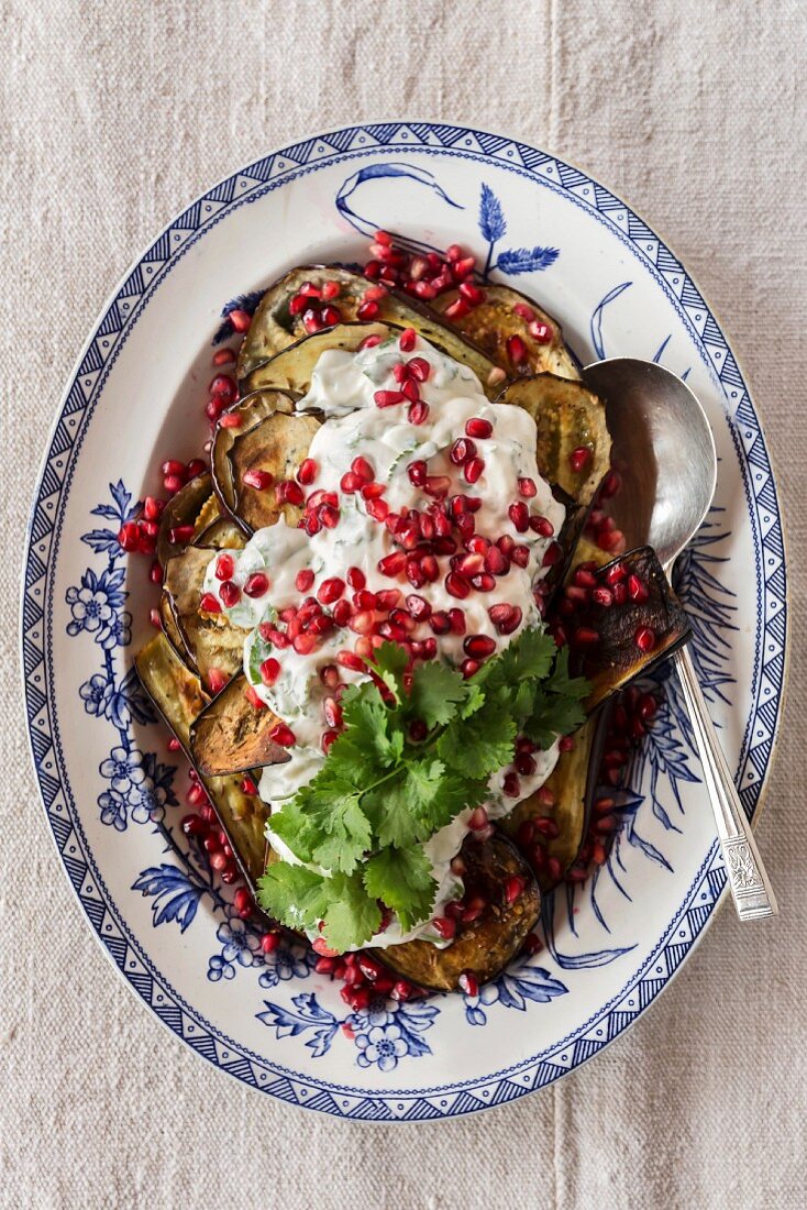 Oven-roasted aubergines with Greek yoghurt and pomegranate seeds
