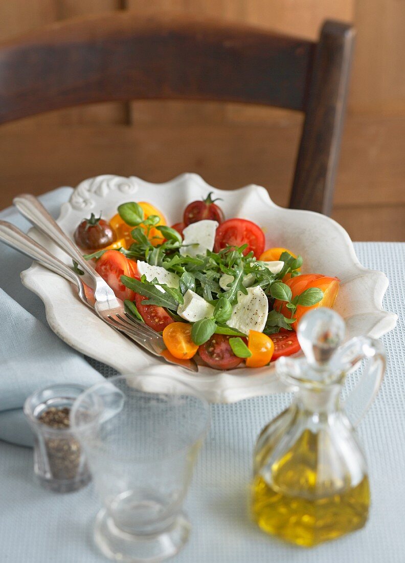 Tomato salad with mozzarella, rocket and basil
