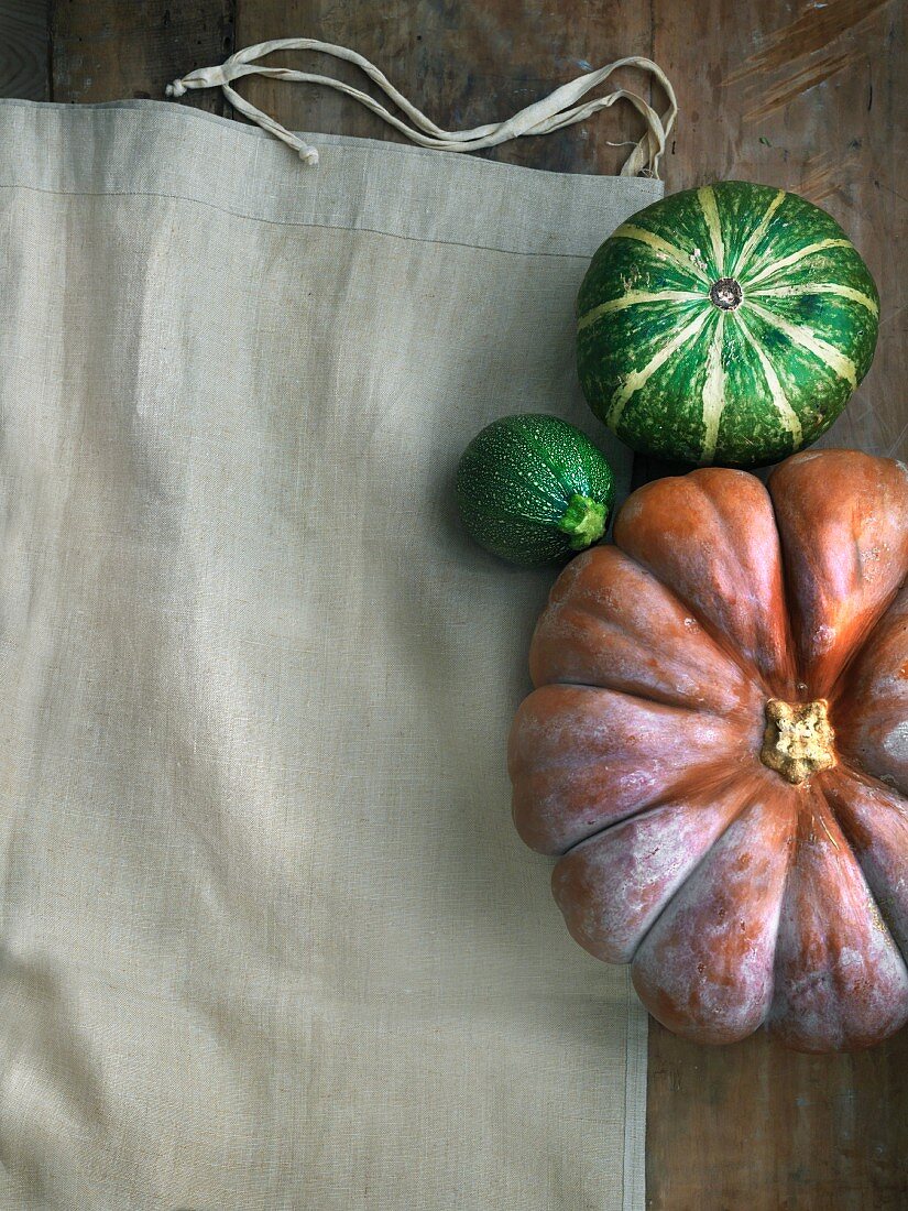 Pumpkin and courgettes on a linen cloth