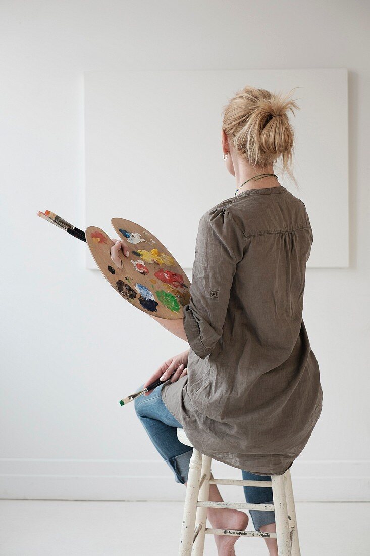 Female artist painting in studio