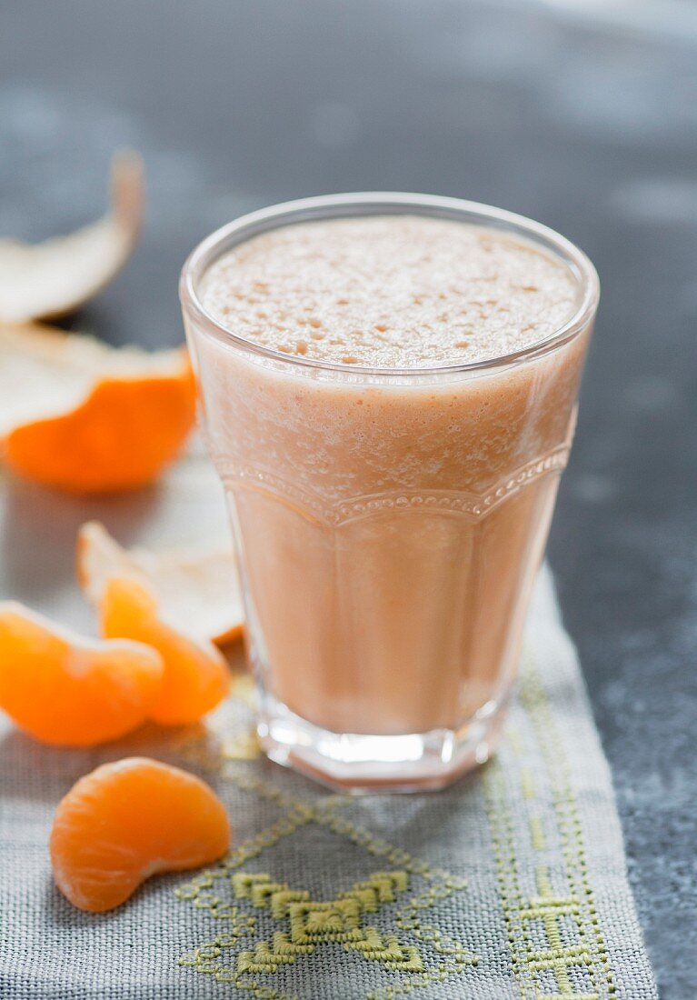 A smoothie with banana, carrots and mandarins