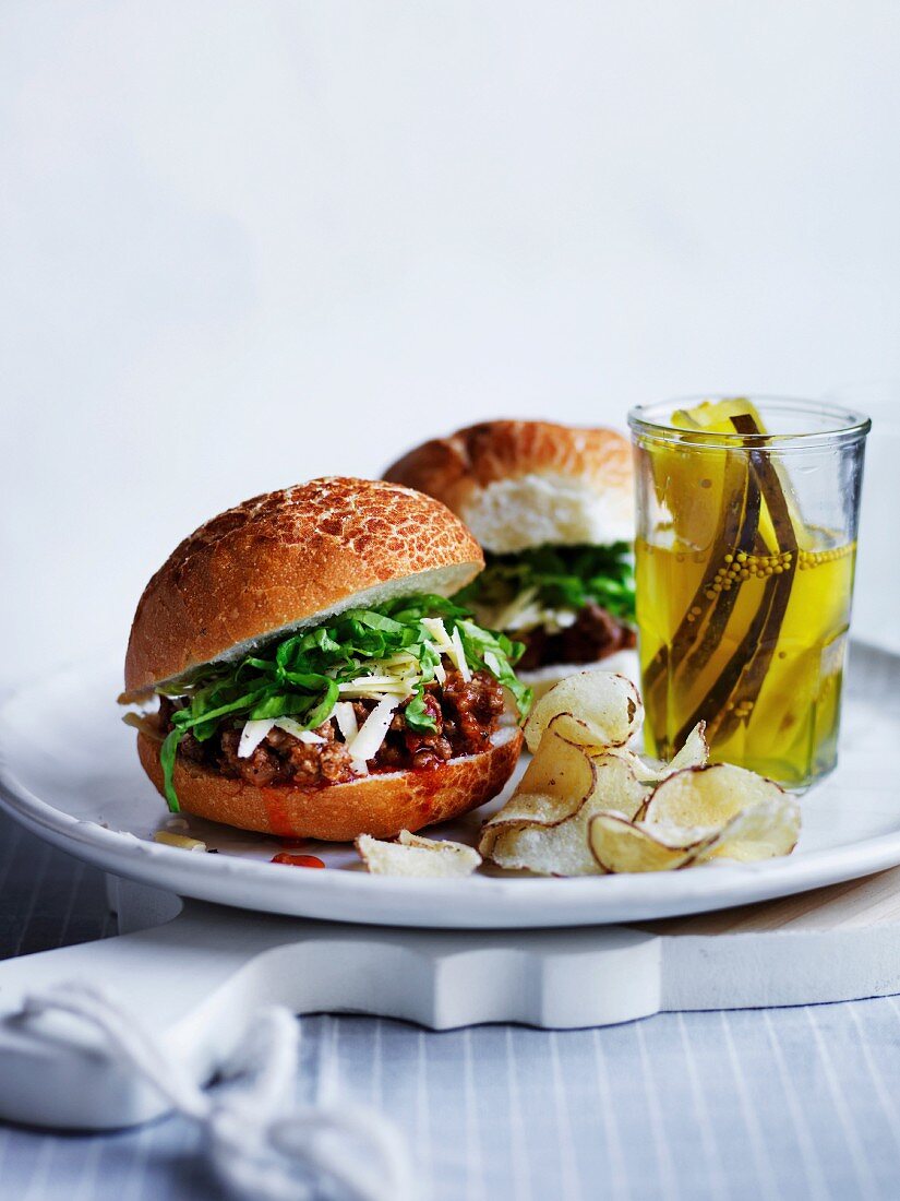 Sloppy Joe with cheese, served with pickles and chips