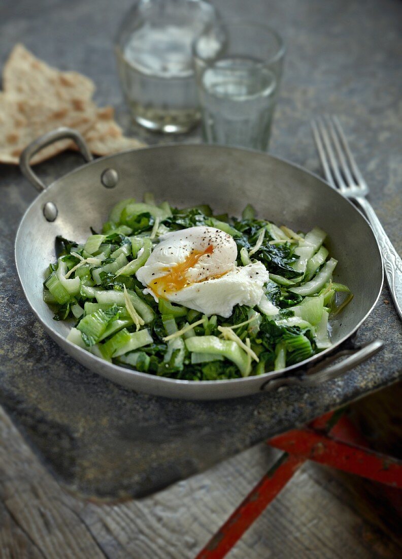 Fried green vegetables with a poached egg (India)