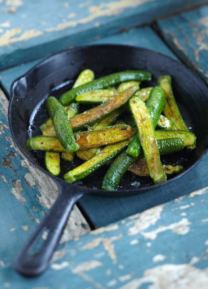 Fried courgette in a pan