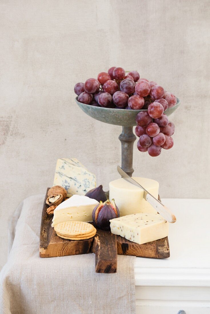 Cheese platter featuring Havarti, Brie, Danish caraway cheese, blue cheese, figs, crackers, grapes and nuts