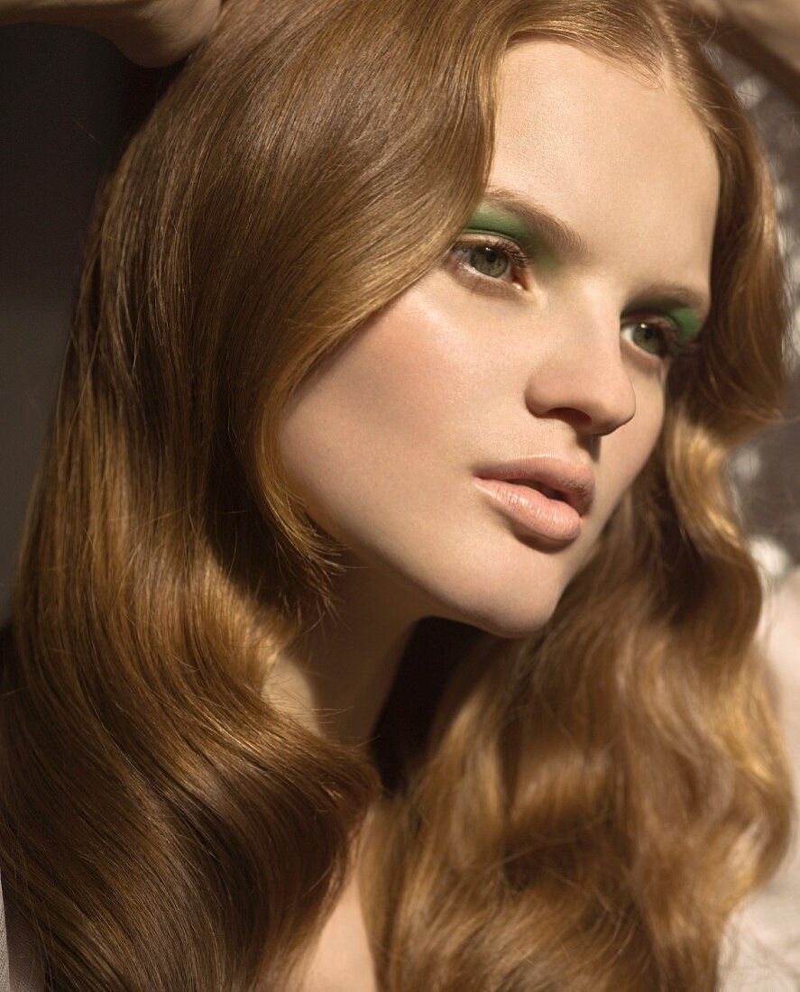 A portrait of a young woman wearing green eyeshadow