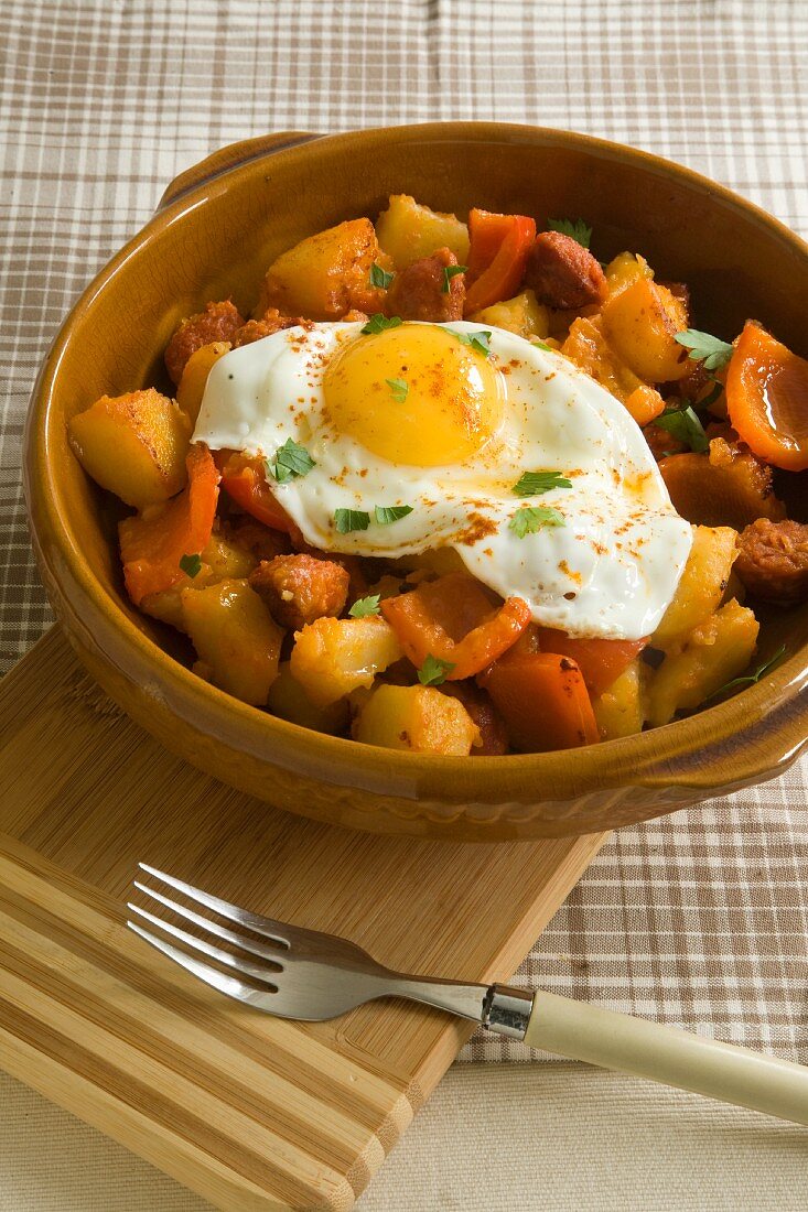 Potatoes with chorizo, peppers and fried egg