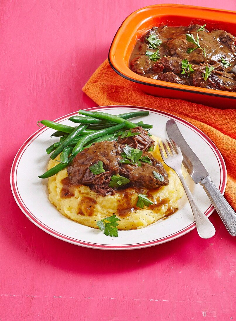 Beef cheeks braised in red wine on polenta with green beans