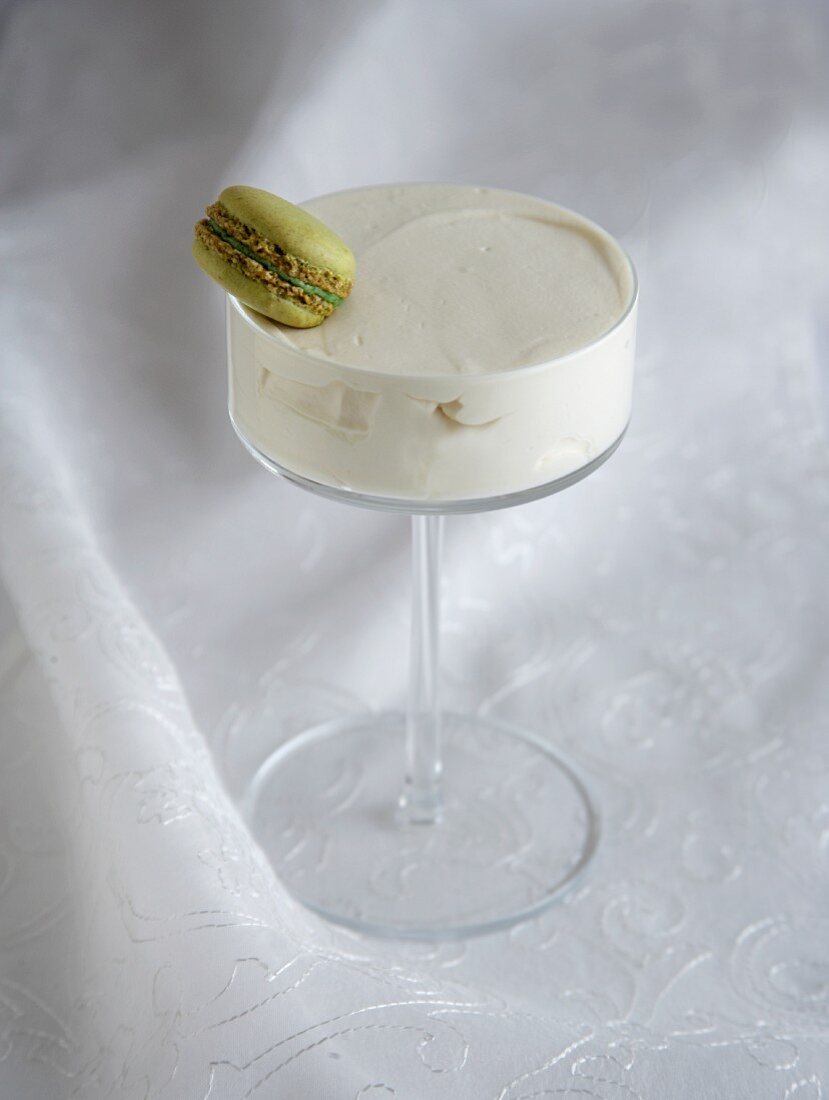 White chocolate cream with a macaroon in a stemmed glass
