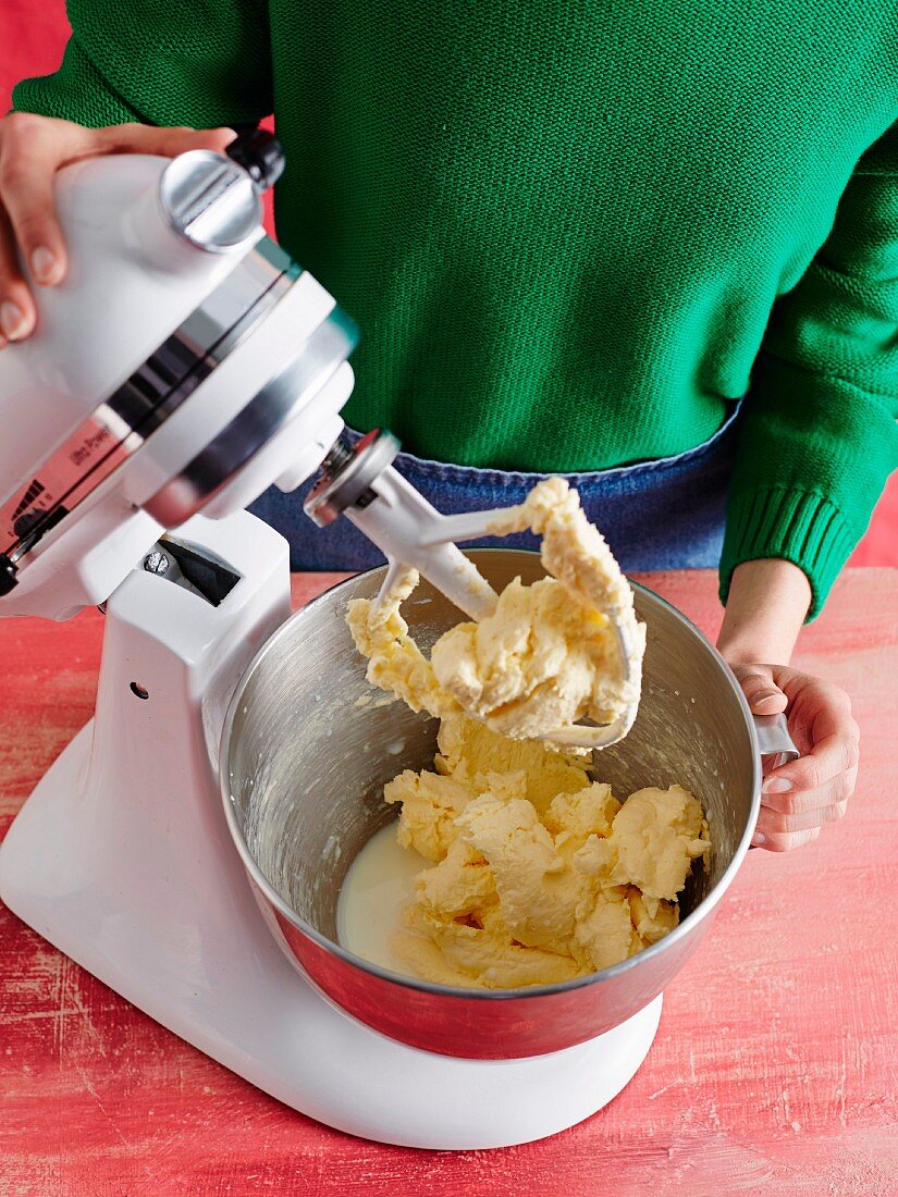 A woman making cake mixture with a food processor