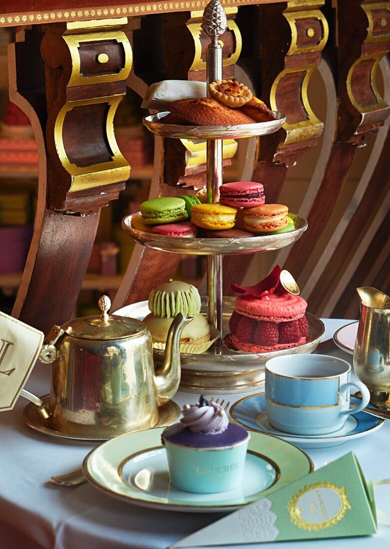 Cupcakes and macaroons on a cake stand for teatime in a restaurant