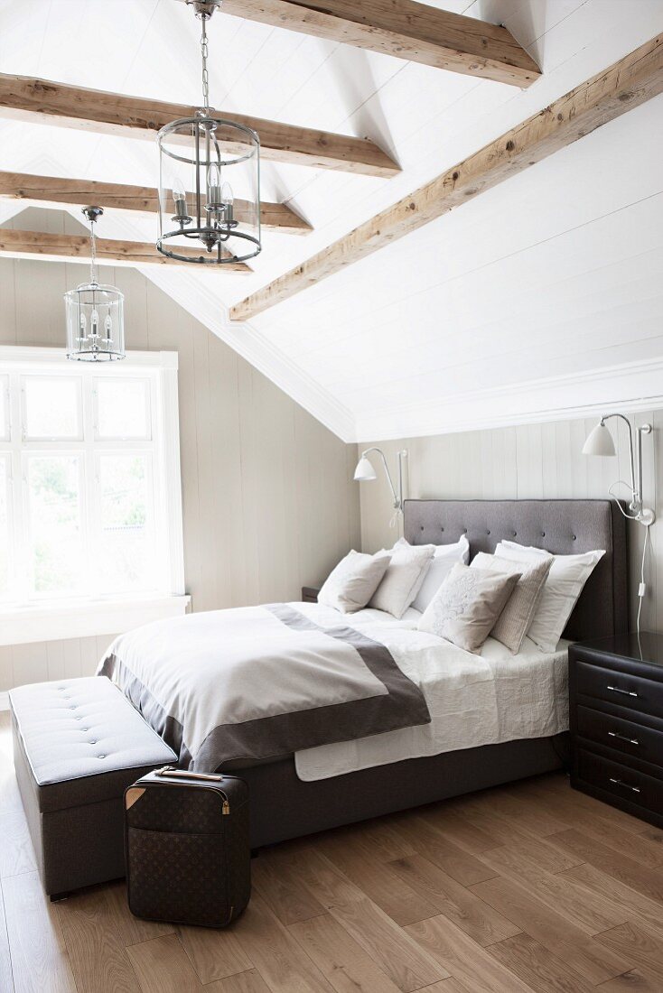 Attic bedroom with exposed beams and … – License image – 11433164 Image ...