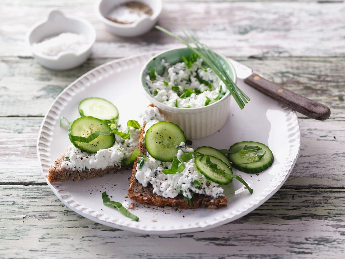 Wholemeal bread topped with herb cottage cheese and fresh cucumbers