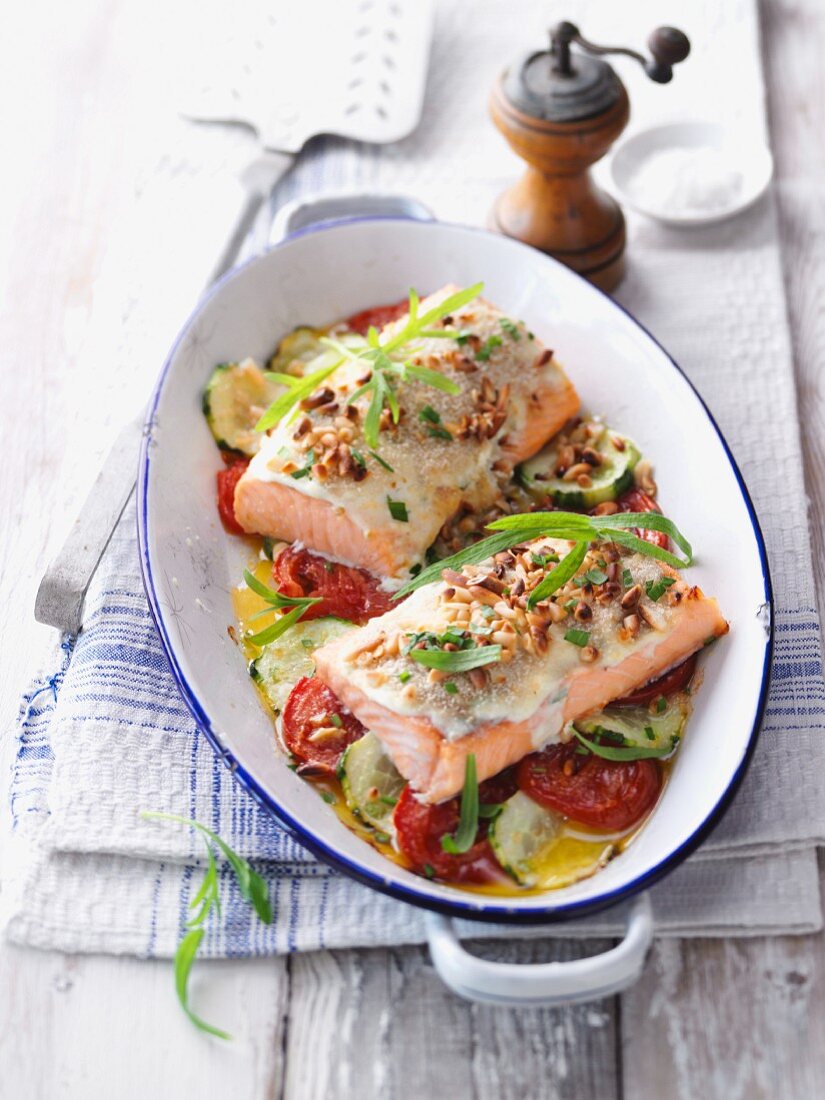 Gratinated salmon fillet with tarragon on a tomato and cucumber medley