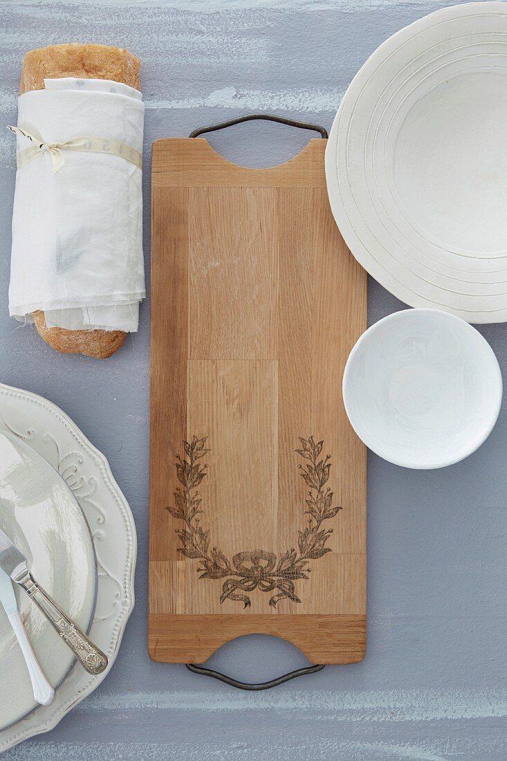 Ornate wooden bread board on table