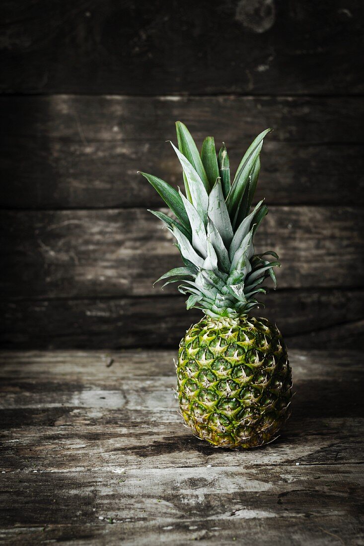 A pineapple on a wooden surface