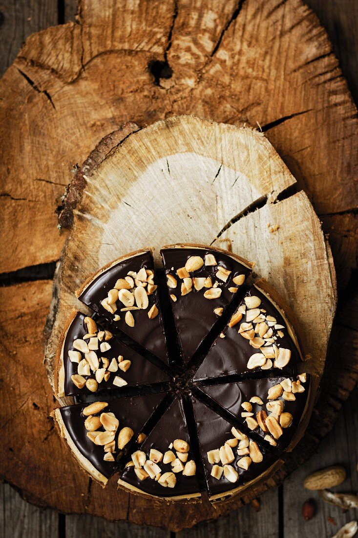 Cheesecake with a chocolate glaze and peanuts (seen from above)
