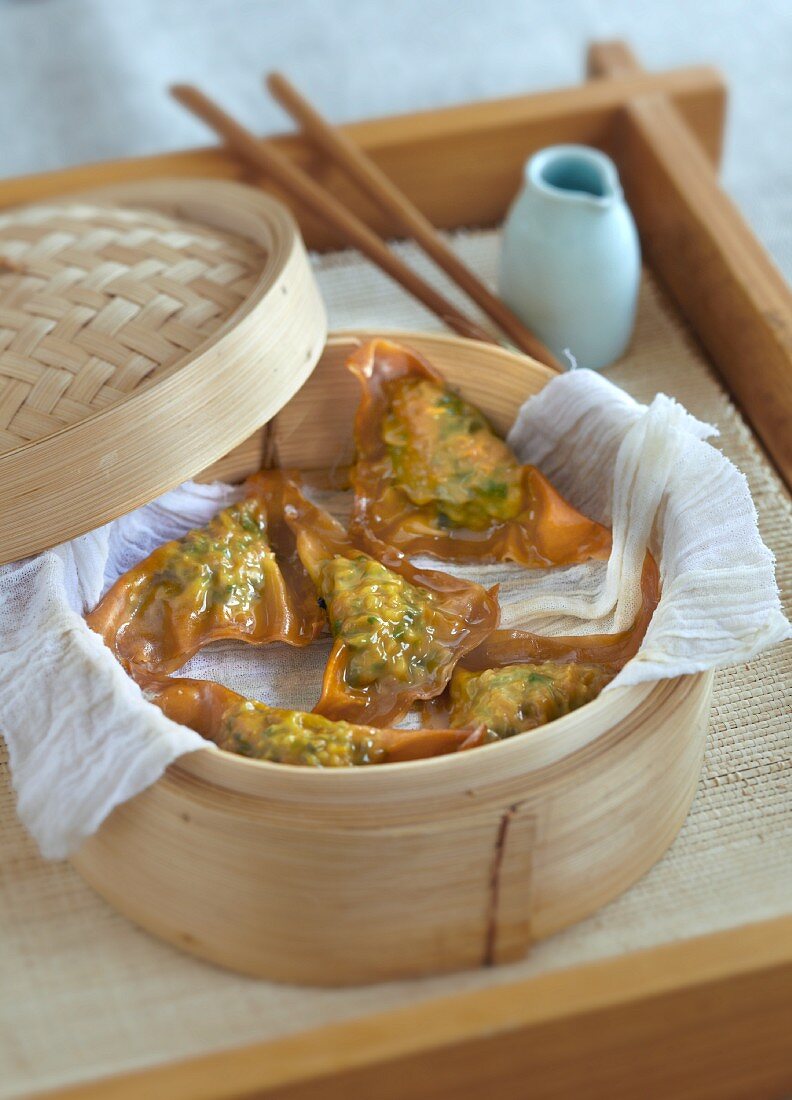 Steamed pastry parcels in a bamboo steamer (China)
