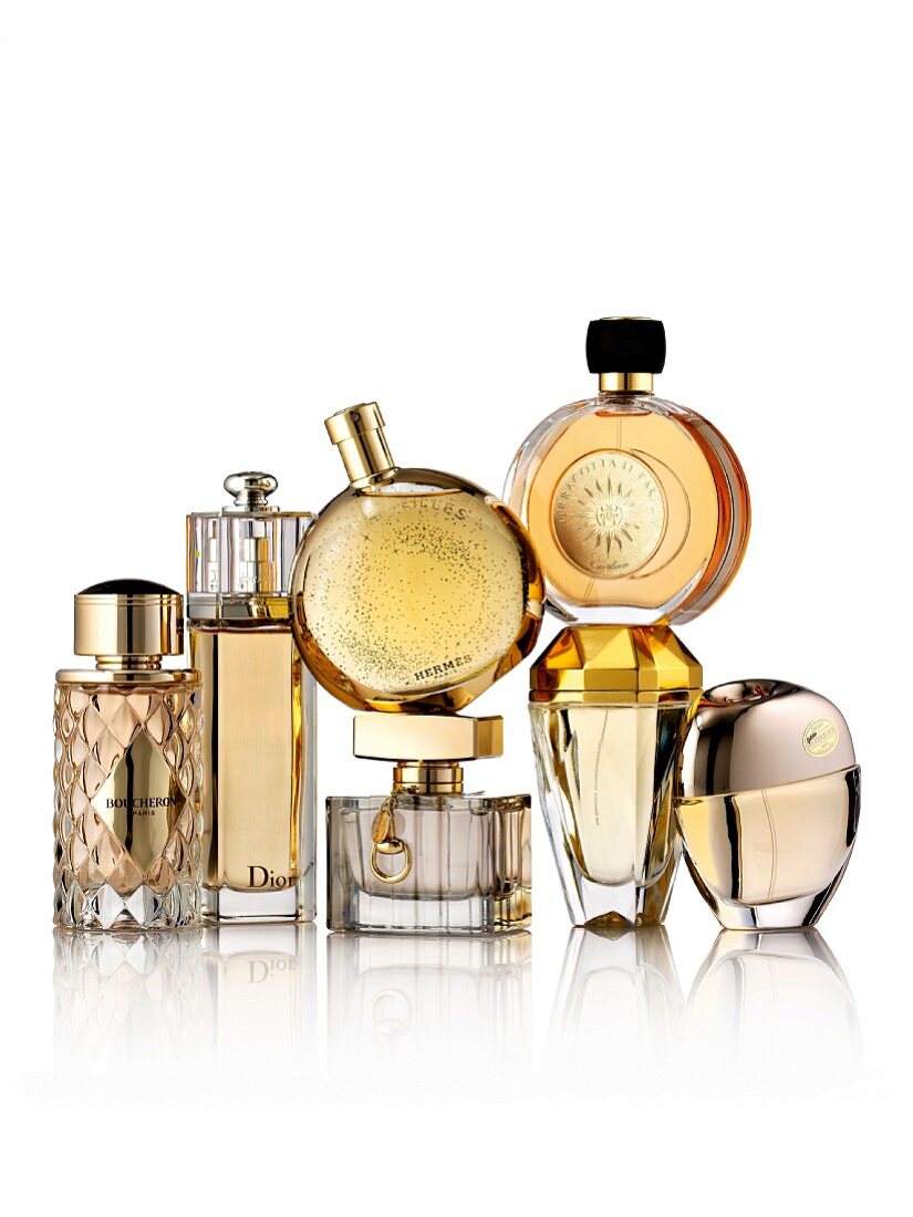 Various bottles of perfume on a white surface