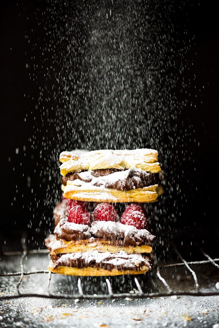 Mille feuilles with chocolate cream, raspberries and icing sugar