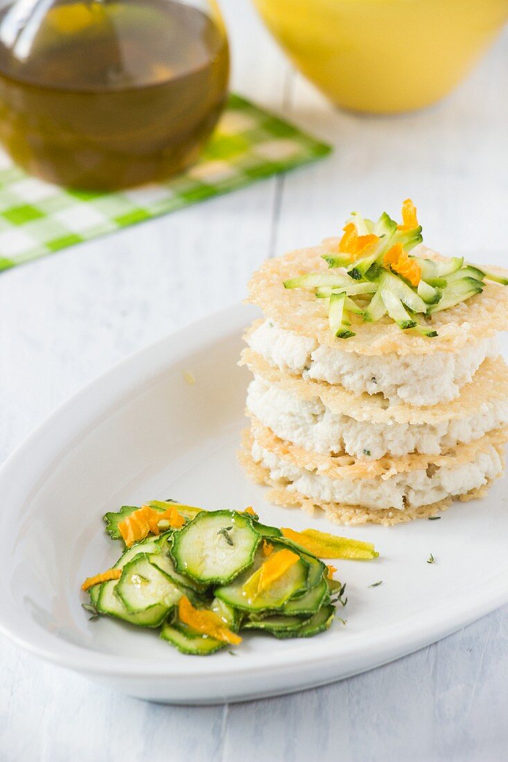 Parmesan mille feuille with fish mousse and a courgette salad