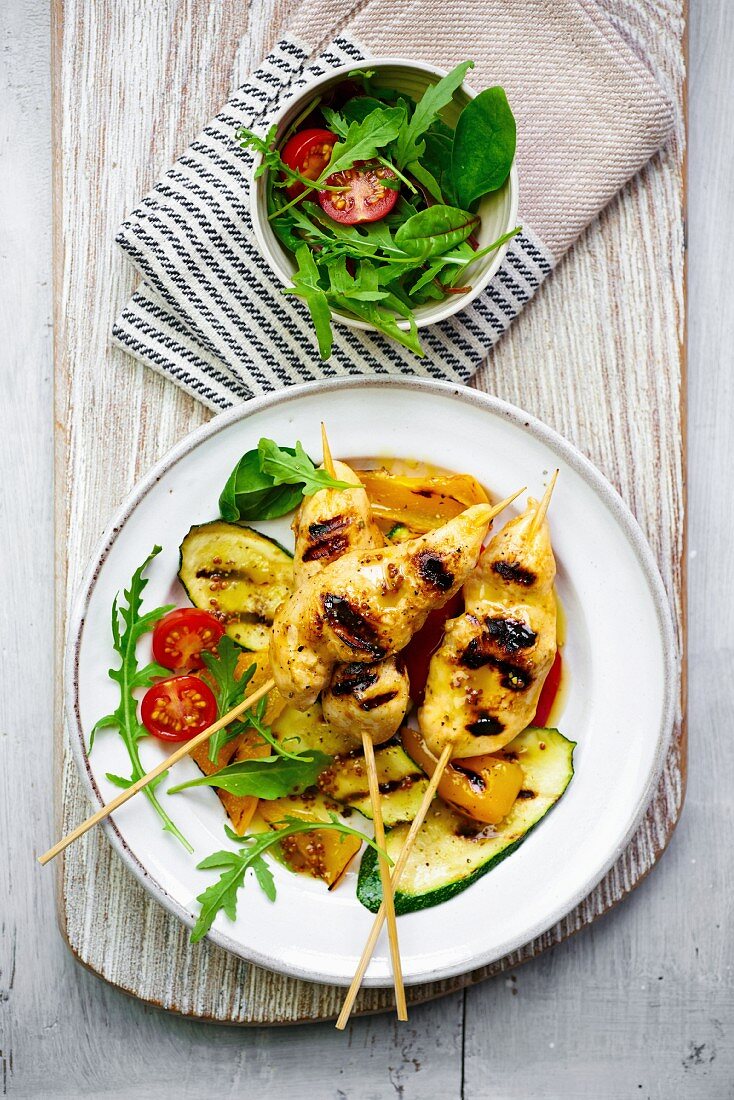 Chicken skewers with grilled vegetables and salad