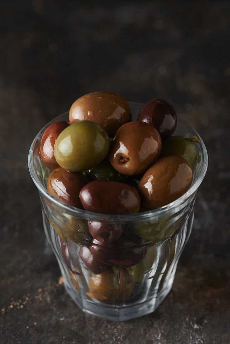 A glass of black and green olives