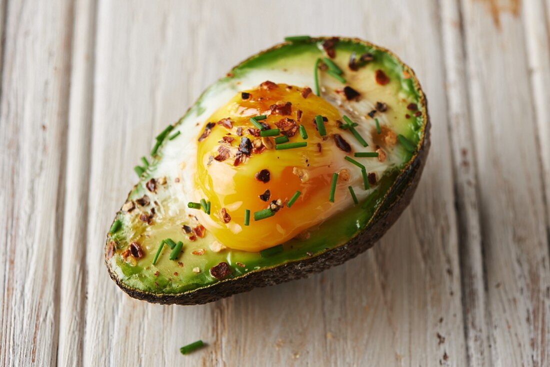Baked avocado with an egg and chives