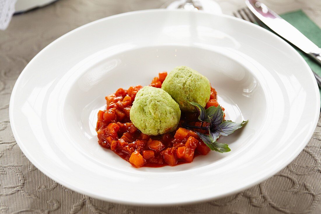 Spinach dumplings on pumpkin goulash