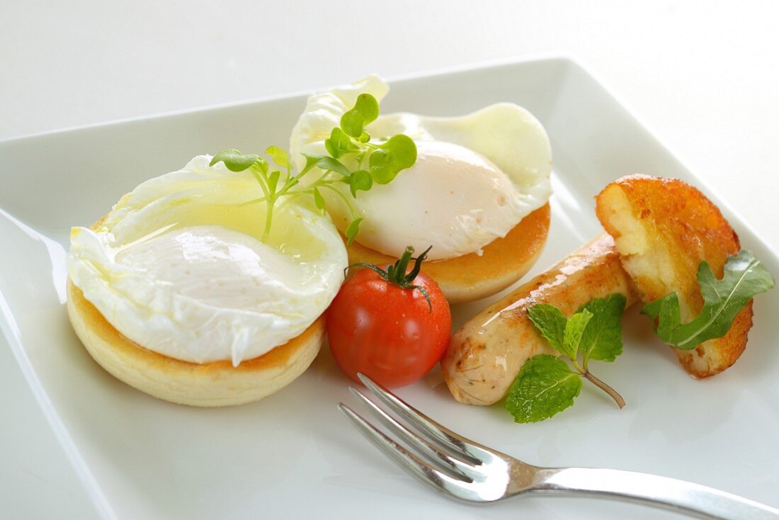 Poached eggs with sausages and a tomato