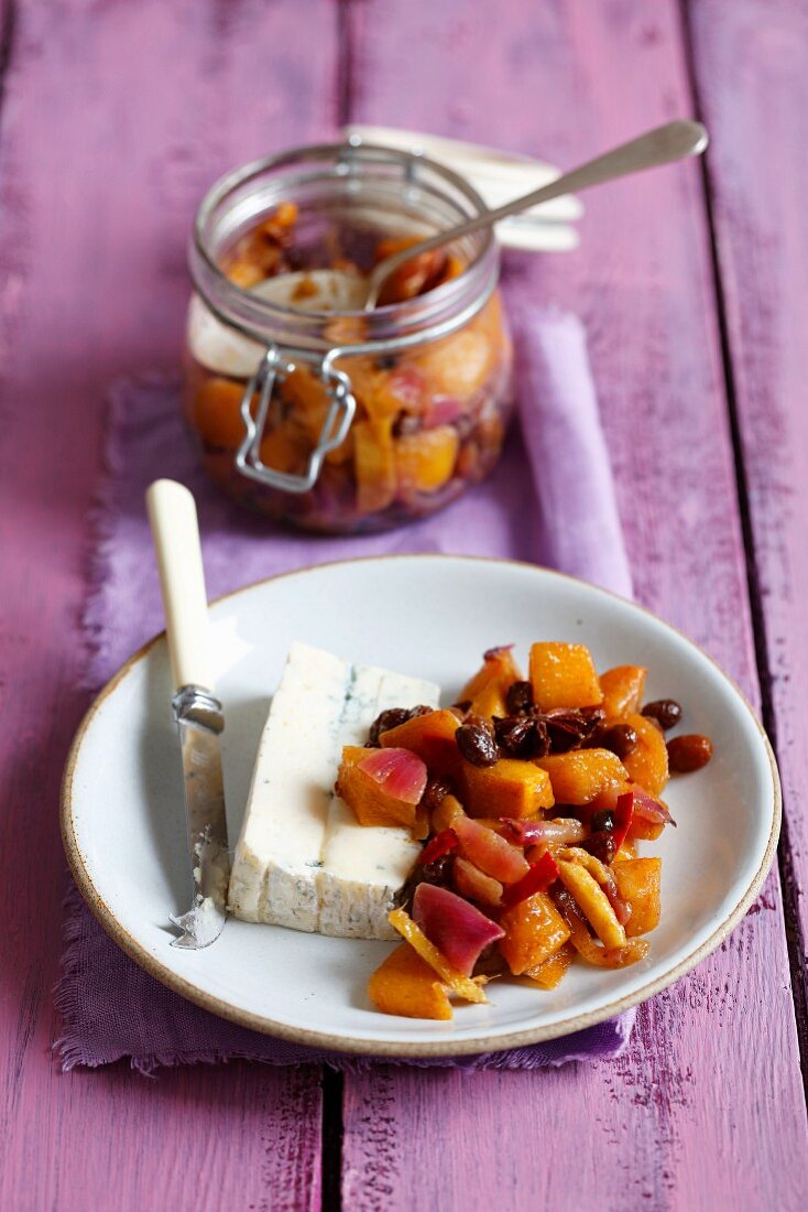Persimmon chutney with red onions, raisins, ginger and chilli with a piece of gorgonzola