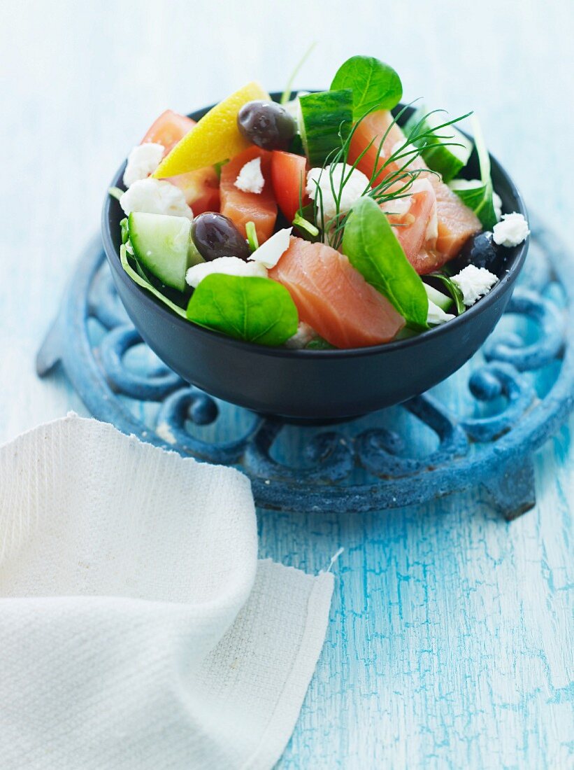 Vegetable salad with salmon, olives and feta cheese