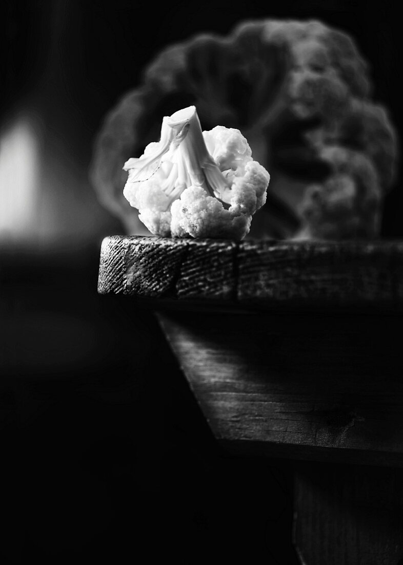 A cauliflower on a wooden table